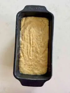 dandelion loaf cake batter in tin