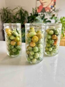 pickled green tomatoes in pretty jars